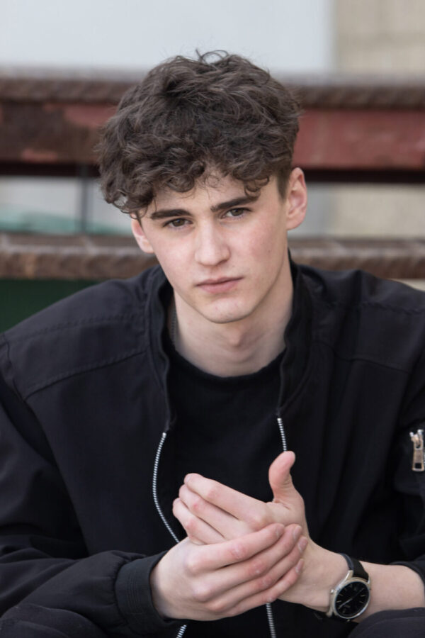 Male actor modelling headshot in urban background in Calgary Alberta